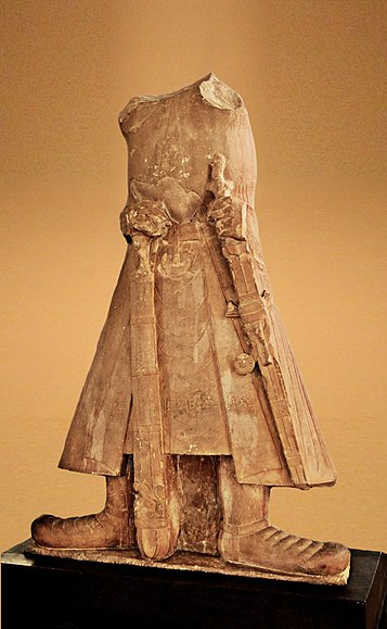 Statue of Kushan Emperor Kanishka I in long coat and boots in Mathura Museum